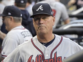 In this Friday, Aug. 3, 2018 file photo, Atlanta Braves manager Brian Snitker looks on from the dugout before a baseball game against the New York Mets in New York.