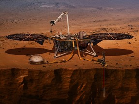 This illustration made available by NASA in 2018 shows the InSight lander drilling into the surface of Mars.