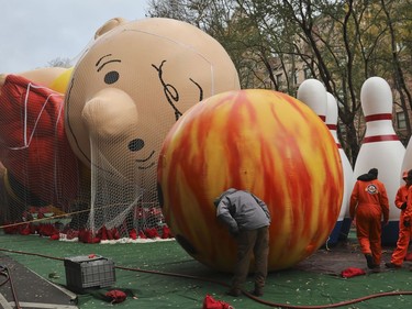 Giant character balloons, including Charlie Brown and Go Bowling, are inflated the night before their appearance in the 92nd Macy's Thanksgiving Day parade, Wednesday Nov. 21, 2018, in New York.