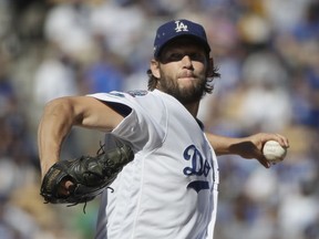 In this Oct. 17, 2018, file photo, Los Angeles Dodgers starting pitcher Clayton Kershaw throws during Game 5 of the NLCS against the Milwaukee Brewers in Los Angeles.