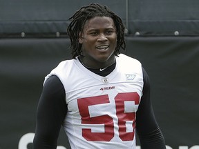 In this May 30, 2018, file photo, San Francisco 49ers linebacker Reuben Foster walks on the field during a practice at the team's NFL training facility in Santa Clara, Calif.