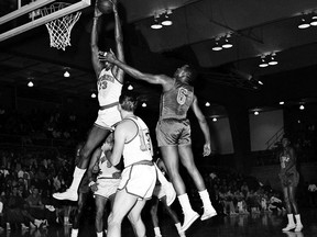 FILE - In this October 1962 file photo, San Francisco Warriors' Wilt Chamberlain (13) goes up to score as New York Knicks' Willie Naulls (6) defends during a basketball game in San Francisco. Warriors' Tom Gola (15) is in the foreground.  Naulls, the former UCLA star who was a four-time All-Star with the Knicks and won three NBA championships with the Boston Celtics, has died. He was 84. Naulls died on Thanksgiving at his home in Laguna Niguel, south of Los Angeles, UCLA said. (AP Photo, File) ORG XMIT: NY155