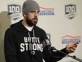 Green Bay Packers quarterback Aaron Rodgers wears a sweatshirt that reads "Butte Strong" in support of the victims of the Camp Fire in Butte County, Calif., as he talks to reporters following the Packers' NFL football game against the Seattle Seahawks, Thursday, Nov. 15, 2018, in Seattle. The Seahawks won 27-24.