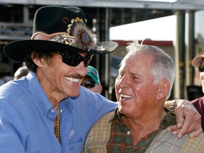 In this Friday, March 6, 2009 file photo, former NASCAR drivers Richard Petty, left, and David Pearson share a laugh during practice for the Kobalt 500 NASCAR Sprint CUp auto race at Atlanta Motor Speedway in Hampton, Ga. NASCAR’s Silver Fox David Pearson has died at 83. Pearson was a three-time Cup champion and his 105 career victories trail only Richard Petty's 200 wins on NASCAR's all-time list.