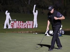 Phil Mickelson celebrates after sinking a put to defeat Tiger Woods at a playoff hole at Shadow Creek golf course, Friday, Nov. 23, 2018, in Las Vegas. (AP Photo/John Locher)