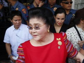 In this Oct. 16, 2018, file photo, former Philippines first lady and widow of the late dictator Ferdinand Marcos, Congresswoman Imelda Marcos arrives at the Commission on Elections to lend her support for her daughter Governor Imee Marcos in filing her Certificate of Candidacy or COC for a Senate seat in the May 2019 midterm elections in Manila, Philippines.