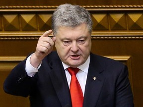 Ukrainian President Petro Poroshenko gestures during a parliament session in Kiev, Ukraine, Monday, Nov. 26, 2018.