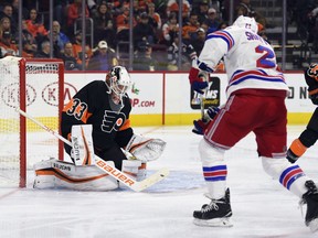 Flyers goaltender Calvin Pickard makes a save on a shot from Rangers' Kevin Shattenkirk (22) during NHL action in Philadelphia, Friday, Nov. 23, 2018.