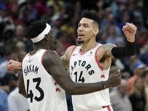 Raptors' Danny Green (14) celebrates his game-winning shot against the Magic with teammate Pascal Siakam on Tuesday night in Orlando. (AP Photo/John Raoux))