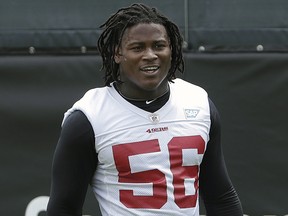 In this May 30, 2018, file photo, 49ers linebacker Reuben Foster walks on the field during a practice at the team's NFL training facility in Santa Clara, Calif. Foster was arrested Saturday, Nov. 24, at the team hotel on charges of domestic violence.