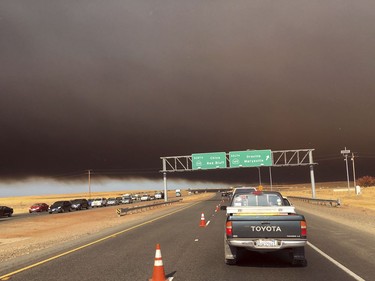 Smoke from the Camp Fire, burning in the Feather River Canyon near Paradise, Calif., darkens the sky as seen from Highway 99 near Marysville, Calif., Thursday, Nov. 8, 2018.