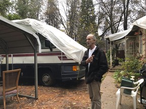Resident Stewart Nugent who stayed in his home and fought off the flames of a deadly wildfire stands outside his surviving home in Paradise, Calif., on Friday, Nov. 23, 2018.
