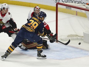 Sabres forward Jason Pominville puts the puck past Senators netminder Craig Anderson in the first period for one of Pominville's two goals during Saturday's contest.