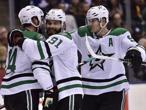 Dallas Stars’ Jamie Benn (left) celebrates his goal against hte Maple Leafs in Toronto on Thursday night with teammates Tyler Seguin (centre) and Jason Spezza. Spezza played his 1,000th NHL game this week and says he doesn’t sweat the financial issues any more and simply plays for the love of the game.