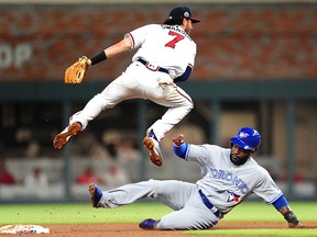 Dansby Swanson of the Atlanta Braves turns a double play against Dwight Smith, Jr. of the Toronto Blue Jays at SunTrust Park on May 18, 2017 in Atlanta. (Scott Cunningham/Getty Images)