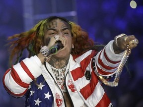 FILE- In this Sept. 21, 2018, file photo rapper Daniel Hernandez, known as Tekashi 6ix9ine, performs during the Philipp Plein women's 2019 Spring-Summer collection, unveiled during the Fashion Week in Milan, Italy. Federal authorities say Hernandez is in custody and awaiting a Manhattan court appearance. The Brooklyn-based rapper, whose legal name is Daniel Hernandez, is among four people arrested on racketeering and firearms charges.