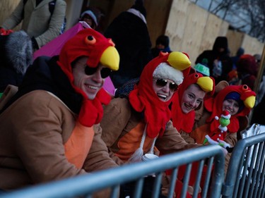 People try to stay warm before the 92nd annual Macy's Thanksgiving Day Parade in New York, Thursday, Nov. 22, 2018.