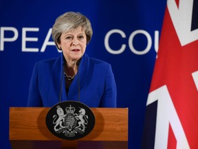 Britain's Prime Minister Theresa May gives a press conference after a special meeting of the European Council to endorse the draft Brexit withdrawal agreement and to approve the draft political declaration on future EU-UK relations in Brussels on Sunday, Nov. 25, 2018.