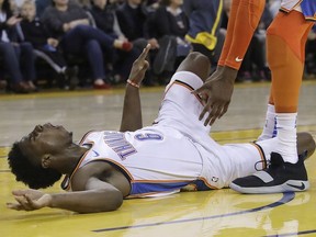 Oklahoma City Thunder guard Hamidou Diallo (6) reacts after being injured during the second half of the team's NBA basketball game against the Golden State Warriors in Oakland, Calif., Wednesday, Nov. 21, 2018. Diallo left the game on a stretcher after the play.