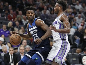 Timberwolves guard Jimmy Butler (23) battles for position against Kings guard Buddy Hield (24) during the first half of an NBA game in Sacramento, Calif., Friday, Nov. 9, 2018.