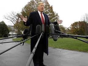 President Donald Trump talks to the media before boarding Marine One on the South Lawn of the White House, Friday, Nov. 9, 2018, in Washington.