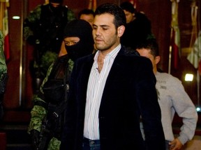 Vicente Zambada Niebla, aka "El Vicentillo", one of the leaders of the Sinaloa drug cartel, led by fugitive Joaquin Loera, aka "El Chapo", is taken under custody to be presented to the press at the attorney general's office in Mexico City March 19, 2009. (LUIS ACOSTA/AFP/Getty Images)