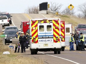 Emergency medical personnel gather at the scene of a hit-and-run accident Saturday, Nov. 3, 2018, in Lake Hallie, Wis., that killed two girls and an adult.