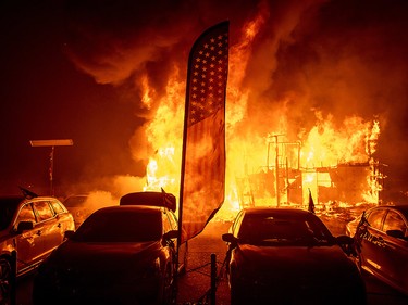 Flames consume a car dealership as the Camp Fire tears through Paradise, Calif., on Thursday, Nov. 8, 2018.