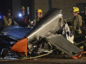 In this Saturday, Nov. 17, 2018, photo firefighters and investigators look over a vintage World War II P-51D Mustang aircraft after a deadly crash in Fredericksburg, Texas. (Billy Calzada/The San Antonio Express-News via AP) ORG XMIT: TXSAE201