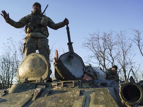 Ukrainian soldiers stand atop an APC near Urzuf, south coast of Azov sea, eastern Ukraine, Thursday, Nov. 29, 2018. Ukraine put its military forces on high combat alert and announced martial law this week after Russian border guards fired on and seized three Ukrainian ships in the Black Sea.