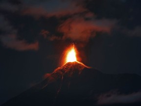 In this image taken with a long exposure, the Volcan de Fuego, or Volcano of Fire, spews hot molten lava from its crater in Antigua, Guatemala, early Monday, Nov. 19, 2018.