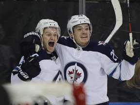 Winnipeg Jets' Bryan Little (left) celebrates his game-tying goal against the Rangers in New York on Sunday. (GETTY IMAGES)