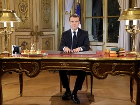 French President Emmanuel Macron poses before a special address to the nation, his first public comments after four weeks of nationwide 'yellow vest' protests, at the Elysee Palace, in Paris, Monday, Dec. 10, 2018.  (Ludovic Marin/Pool Photo via AP)