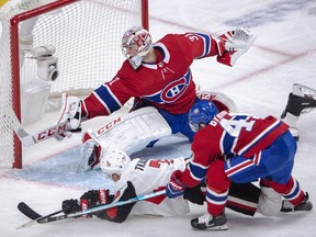 Montreal Canadiens goaltender Carey Price makes the save on Ottawa Senators winger Brady Tkachuk during Tuesday's game. (THE CANADIAN PRESS)