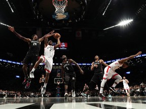 Raptors' Kawhi Leonard shoots against Nets' Rondae Hollis-Jefferson during Friday's game in Brooklyn. (GETTY IMAGES)