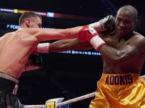 Oleksandr Gvosdyk (black trunk) punches Adonis Stevenson (gold trunk) during their WBC light heavyweight championship fight at the Videotron Center on Dec. 1, 2018 in Quebec City, Que.