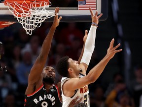 Nuggets' Jamal Murray #27 puts up a shot against Serge Ibaka of the Raptors at the Pepsi Center in Denver last night. (Photo by Matthew Stockman/Getty Images)