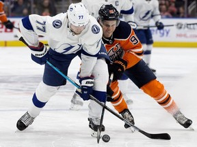 Edmonton Oilers' Jesse Puljujarvi battles the Tampa Bay Lightning' Victor Hedman during first period NHL action at Rogers Place, in Edmonton Saturday Dec. 22, 2018.