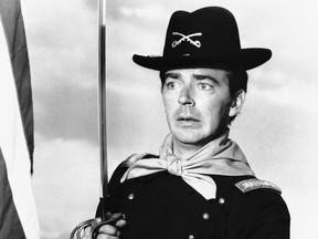 In a  July 1, 1965 file photo, Ken Berry, who plays Captain Wilton Parmenter in a TV series called "F Troop," reaches down the wrong end of cannon in one of the show's episodes. (AP Photo, File)