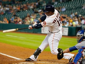 Luis Valbuena of the Houston Astros hits a RBI double in the first inning of their game against the Toronto Blue Jays at Minute Maid Park on May 14, 2015 in Houston, Texas.
