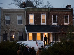 In this Nov. 19, 2018 file photo, a police officer enters a row home to investigate a fatal shooting in Philadelphia.
