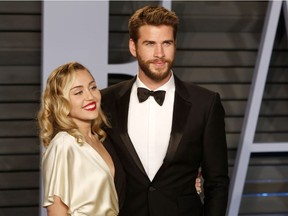 Miley Cyrus and Liam Hemswroth attend the 2018 Vanity Fair Oscar Party hosted by Radhika Jones at Wallis Annenberg Center for the Performing Arts on March 4, 2018 in Beverly Hills, Calfornia.