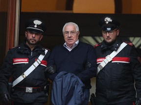 Settimo Mineo, centre, who allegedly took over as the Palermo head of Cosa Nostra, is escorted by Italian Carabinieri police after an anti Mafia operation which led the arrest of 46 people including the presumed regional boss, in Palermo, Sicily, Italy, Tuesday, Dec. 4, 2018. (Igor Petyx/ANSA via AP)