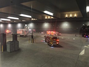 This photo provided by Lynn Krugman and taken through a window shows emergency personnel responding after an "equipment failure" involving a jet bridge at Baltimore-Washington International Thurgood Marshall Airport, Saturday, Dec. 29, 2018, in Baltimore. (Lynn Krugman via AP)