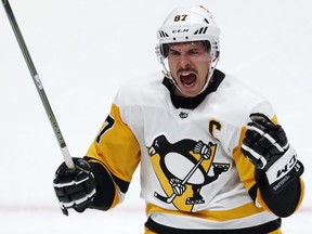 Pittsburgh Penguins center Sidney Crosby reacts after his hat trick against the Colorado Avalanche, during the third period of an NHL hockey game Wednesday, Nov. 28, 2018, in Denver. (AP Photo/David Zalubowski)