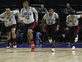 Chicago Bulls Jabari Parker, from left, Cristiano Felicio, Kris Dunn and Shaquille Harrison, warm up at the start of a basketball practice at the Mexico City Arena in Mexico City, Wednesday, Dec. 12, 2018. (AP Photo/Rebecca Blackwell)