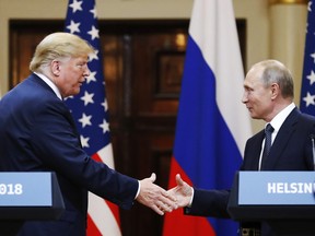 In this file photo taken on Monday, July 16, 2018, U.S. President Donald Trump shakes hand with Russian President Vladimir Putin at the end of the press conference after their meeting at the Presidential Palace in Helsinki, Finland.  (AP Photo/Alexander Zemlianichenko, File)