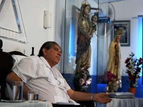 In this file photo taken on April 4, 2012 Brazilian medium Joao de Deus (John of God) (R) gestures while attending his patients at his "Casa de Dom Inacio de Loyola" (House of Don Ignacio de Loyola), in Abadiania, 120 km southwest of Brasilia, state of Goias. - Several women have come forward in Brazil to accuse an internationally known self-proclaimed spiritual healer of sexually abusing them under the pretext of trying to "cure" them of depression or other problems, the widely viewed Global Television network reported on December 7, 2018.