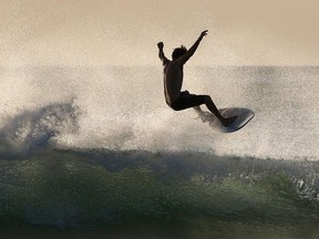 A surfer enjoys the waves at Las Baulas National Marine Park, Playa Grande, Costa Rica on December 10, 2018.