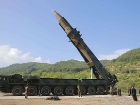FILE - In this July 4, 2017, file photo distributed by the North Korean government, North Korean leader Kim Jong Un, second from right, inspects the preparation of the launch of a Hwasong-14 intercontinental ballistic missile (ICBM) in North Korea's northwest. North Korea on Thursday, Dec. 20, 2018, says it will never unilaterally give up its nuclear weapons unless the United States removes its nuclear threat first. (Korean Central News Agency/Korea News Service via AP, File)